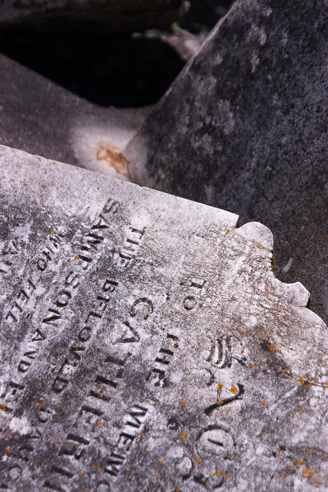 Fallen tombstones of all the people that died on the island