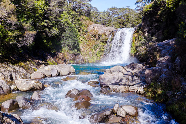 Tawhai waterfall lagoon sparkling with bright sun